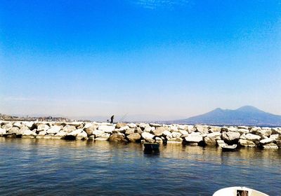 Scenic view of sea against clear blue sky