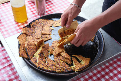 Cropped hand preparing food