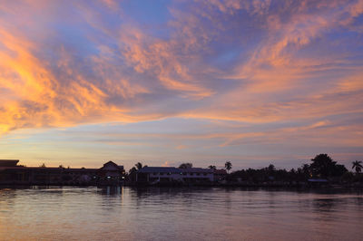 Scenic view of river against sky at sunset