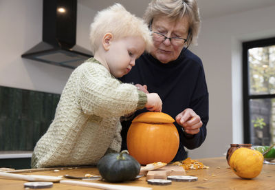 Rear view of woman with pumpkin