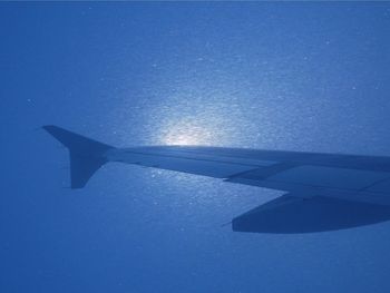 Airplane wing in blue sky