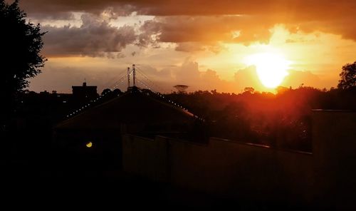 Silhouette buildings against sky during sunset