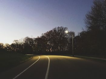 Empty road along trees