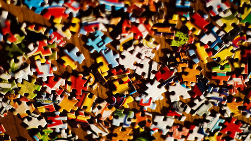 High angle view of multi colored puzzle pieces on table