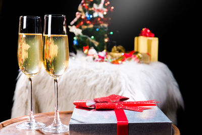 Wineglass on table against black background