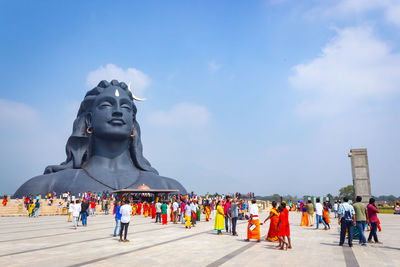 Statue of people against sky