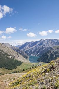 Scenic view of valley and mountains against sky