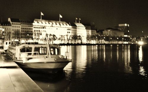 Boats in calm sea at night