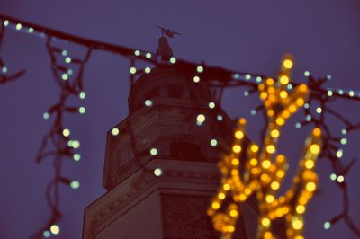 Low angle view of illuminated building at night