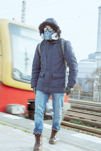 Full length of man standing on railroad track