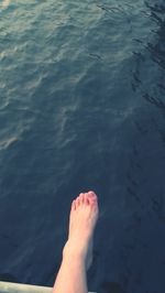 Low section of man relaxing in water