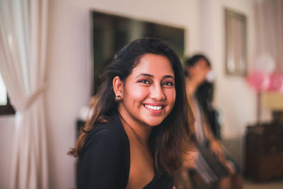 Portrait of smiling young woman indoors