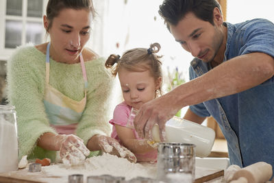 Family preparing food in kitchen