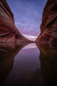 Scenic view of rock formations against cloudy sky