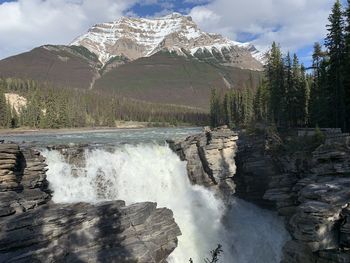 Scenic view of waterfall against sky