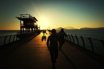 Silhouette of man in sea at sunset