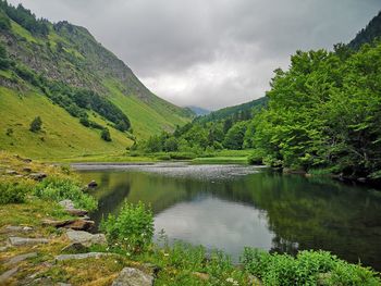 Scenic view of lake and mountains against sky