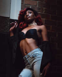 Portrait of beautiful young woman standing indoors