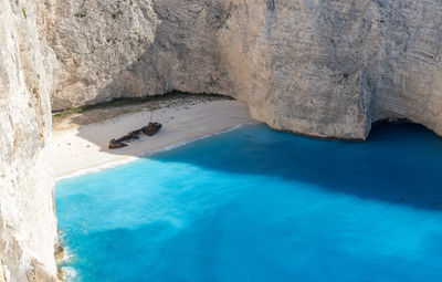 Beautiful view of a deserted beach with a sunken ship.