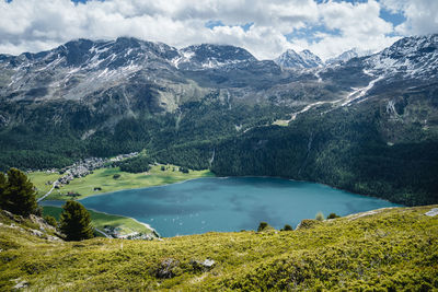 Snow covered mountains above silvaplana lake, engadin, switzerland