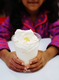 Midsection of woman holding ice cream