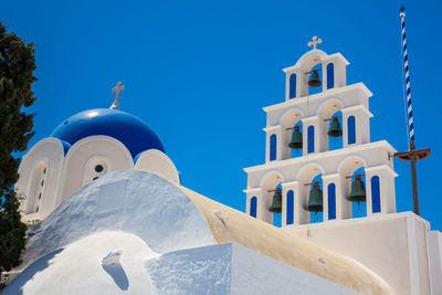 Low angle view of white building against blue sky