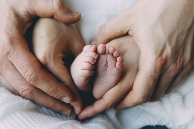 Close-up of baby feet on bed