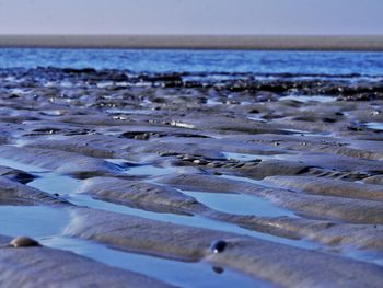 Close-up of beach against sky