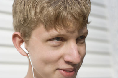 Close-up of teenage boy listening music