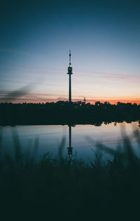 Silhouette of communications tower at sunset