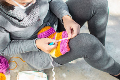 Close-up of hands holding multi colored baby