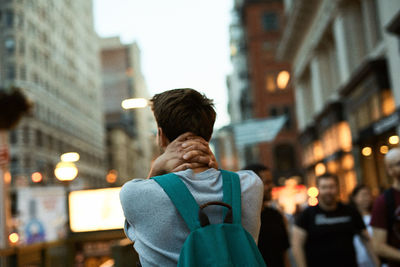 Rear view of man in city at night