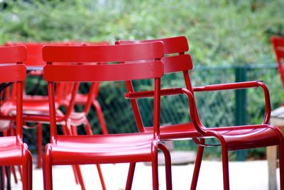 Empty red chairs in lecoq garden