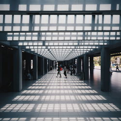 People walking in corridor of building