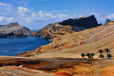 Scenic view of sea and mountains against sky