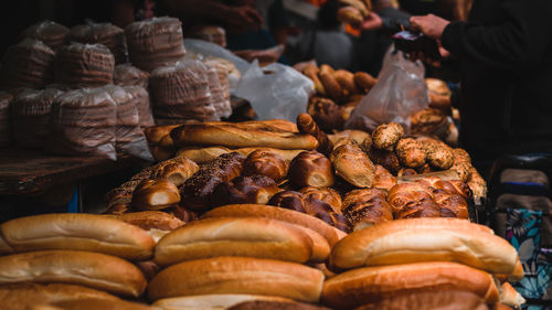 Close-up of baked pastry items for sale at market stall