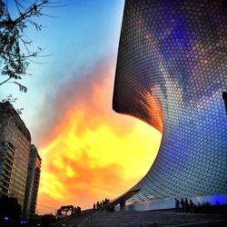 Low angle view of buildings against sky during sunset