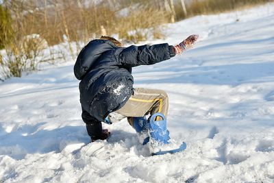 Person playing on snowy field during sunny day