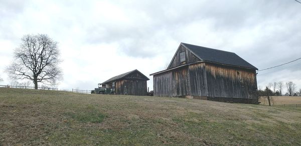 Barn on field against sky