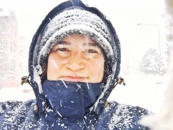 Portrait of young woman covering face
