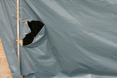 High angle view of person standing on snow covered wall