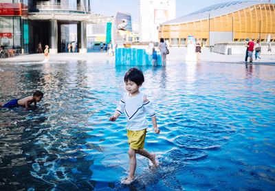 Full length of children in swimming pool