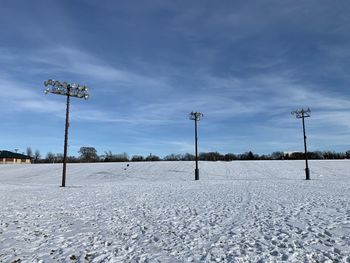 Snow covered field against sky