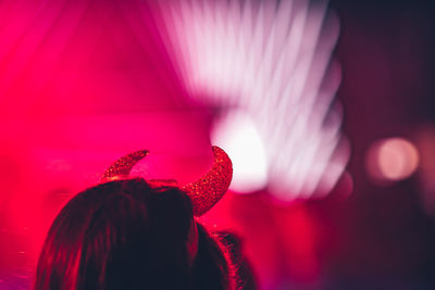 Close-up of woman wearing devil headband