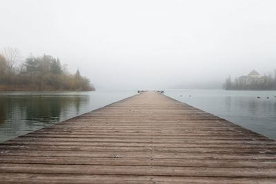 Pier over lake against sky