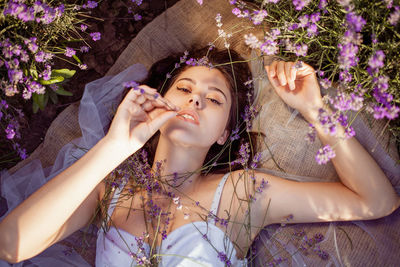 A beautiful young girl against the sunset and a beautiful sky in a lavender field. 