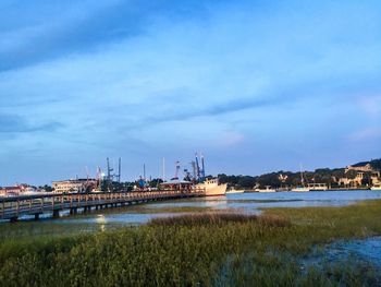 Scenic view of river against cloudy sky