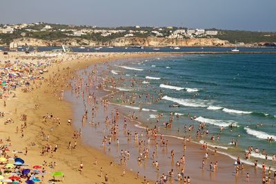 High angle view of people enjoying at beach