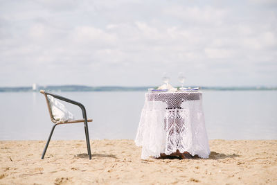 Table and chair for a romantic dinner by the sea, lake or ocean for a honeymoon