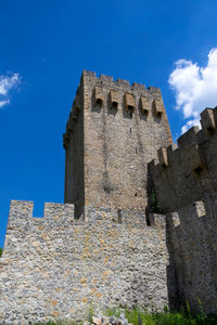 Low angle view of old building against blue sky